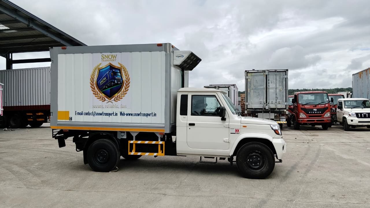 Snow Transport refrigerated truck at a logistics yard